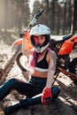 Beautiful hipster girl with a tattoo on his arm and pink hair covering the eye in safety helmet