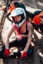 Beautiful hipster girl with a tattoo on his arm and pink hair covering the eye in safety helmet