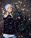 Beautiful hipster woman with Christmas fir tree and lights in knitted sweater blouse Royalty Free Stock Photo