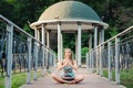 Woman sitting near in the park and playing on happy drum