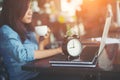 Beautiful hipster woman using laptop at cafe while drinking coffee. Royalty Free Stock Photo