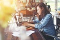 Beautiful hipster woman using laptop at cafe while drinking coffee, Relaxing holiday concept. Royalty Free Stock Photo