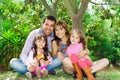 Beautiful hispanic family of four sitting outside Royalty Free Stock Photo