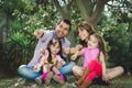 Beautiful hispanic family of four sitting outside Royalty Free Stock Photo