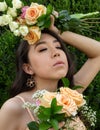 beautiful hispanic indigenous model wearing a peace dress flower crown roses flowers nature trees