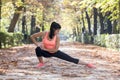 Beautiful hispanic sport woman in sportswear stretching body next smiling happy doing flexibility exercises Royalty Free Stock Photo