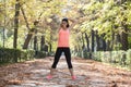 Beautiful hispanic sport woman in sportswear stretching body next smiling happy doing flexibility exercises Royalty Free Stock Photo