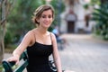 Beautiful hispanic teenage girl sitting on a wooden bench on a p Royalty Free Stock Photo