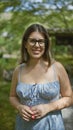 Beautiful hispanic woman in glasses, joyful portrait of her smiling, laughing and posing confident in japan\'s traditional kyoto Royalty Free Stock Photo