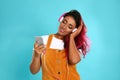 Beautiful Hispanic woman with headphones  music on blue background Royalty Free Stock Photo