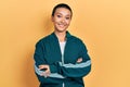 Beautiful hispanic woman with short hair wearing sporty jacket happy face smiling with crossed arms looking at the camera Royalty Free Stock Photo