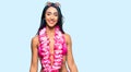 Beautiful hispanic woman wearing bikini and hawaiian lei with a happy and cool smile on face Royalty Free Stock Photo