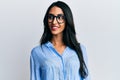 Beautiful hispanic woman wearing business clothes and glasses looking to side, relax profile pose with natural face and confident Royalty Free Stock Photo