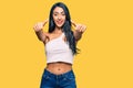 Beautiful hispanic woman wearing casual clothes approving doing positive gesture with hand, thumbs up smiling and happy for Royalty Free Stock Photo