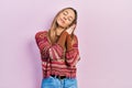 Beautiful hispanic woman wearing hippie sweater sleeping tired dreaming and posing with hands together while smiling with closed Royalty Free Stock Photo
