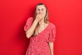 Beautiful hispanic woman wearing summer dress bored yawning tired covering mouth with hand Royalty Free Stock Photo