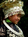 Beautiful Hmong little girl in full festival traditional costume and silver headdress, Guizhou province, China.