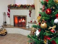 Beautiful holdiay decorated room with Christmas tree. Burning fireplace. Decorated festive fireplace with burning fire Royalty Free Stock Photo