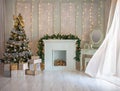 Beautiful holdiay decorated room with Christmas tree with presents under it.