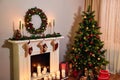 Beautiful holdiay decorated room with Christmas tree with presents under it. Fireplace and decorated Christmas tree un Living room Royalty Free Stock Photo