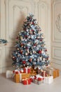 Beautiful holdiay decorated room with Christmas tree and presents under it. New Year decorations Royalty Free Stock Photo