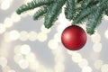 Beautiful holiday bauble hanging on Christmas tree against blurred lights, closeup. Space for text Royalty Free Stock Photo