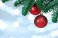 Beautiful holiday baubles hanging on Christmas tree against blurred lights, closeup. Space for text Royalty Free Stock Photo