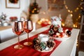 Beautiful holiday decorated kitchen with Christmas tree and bright lights , holiday glasses and christmas composition on the main Royalty Free Stock Photo