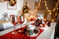 Beautiful holiday decorated kitchen with Christmas tree and bright lights , holiday glasses on the main plan, blur background Royalty Free Stock Photo