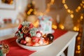 Beautiful holiday decorated kitchen with Christmas tree and bright lights , holiday glasses on the main plan, blur background Royalty Free Stock Photo