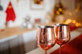 Beautiful holiday decorated kitchen with Christmas tree and bright lights , holiday glasses on the main plan, blur background Royalty Free Stock Photo