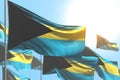 Beautiful holiday flag 3d illustration - many Bahamas flags are waving against blue sky image with selective focus Royalty Free Stock Photo