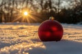 A beautiful holiday ornament capturing the reflection of a winter road at sunset in a snowy Christmas landscape. Royalty Free Stock Photo