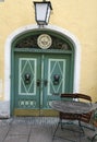 Beautiful home entrance with lamp and round wooden green door