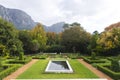 Beautiful home garden with pool, lawn and trees near mountain landscape, copy space