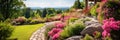 Beautiful home garden view, luxury landscaped house backyard in summer. Banner with lawn, path, rocks, flowers and green plants. Royalty Free Stock Photo