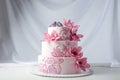 A beautiful home wedding three-tiered cake decorated with pink flowers Royalty Free Stock Photo