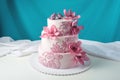 A beautiful home wedding three-tiered cake decorated with pink flowers Royalty Free Stock Photo