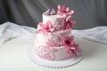 A beautiful home wedding three-tiered cake decorated with pink flowers Royalty Free Stock Photo