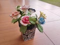 beautiful home accessories a flower replica made of ceramic (rose replica). brown floor as background