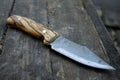 Beautiful homemade knife with a wooden handle lies on the table