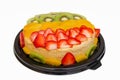 Beautiful homemade flan decorated with colorful fruits.