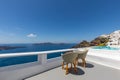 Beautiful honeymoon suit on Santorini island. Romantic two chairs on white caldera with sea view. Luxury travel Royalty Free Stock Photo