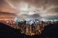 Beautiful Hong Kong island cityscape, aerial night view from Victoria Peak in cloudy storm weather Royalty Free Stock Photo