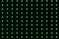 Beautiful horizontal texture of group burning green LED lamps on a dark background