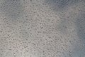 A horizontal texture of water droplets is on the glass and on a background of blue sky Royalty Free Stock Photo