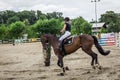 Beautiful horse and jokey in action at horse race track with obstacle equipment at hippodrome Royalty Free Stock Photo