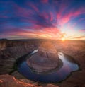 Beautiful Horseshoe Bend sunburst sunset and colorful clouds with reflections Royalty Free Stock Photo