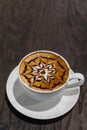 Beautiful hot art mocha coffee on dark wooden table Royalty Free Stock Photo