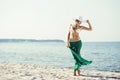 Beautiful, hot blond wearing hat, bikini and green silk Royalty Free Stock Photo